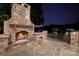 Outdoor stone fireplace with a lake view, perfect for evening relaxation and entertainment at 1873 Farrow Dr, Rock Hill, SC 29732