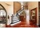 Grand foyer featuring hardwood floors, staircase with black banister, and elegant decor at 1873 Farrow Dr, Rock Hill, SC 29732
