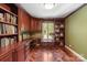 Cozy office with custom built-in shelving, wood floors, and a view to the outdoors providing an ideal work environment at 1873 Farrow Dr, Rock Hill, SC 29732