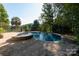 Beautiful in-ground pool and jacuzzi surrounded by a brick patio and lush greenery at 1873 Farrow Dr, Rock Hill, SC 29732