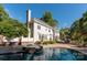 Exterior view of a backyard oasis featuring a swimming pool, spa, and patio with an outdoor fireplace at 1873 Farrow Dr, Rock Hill, SC 29732