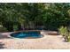 Beautiful in-ground pool and spa surrounded by stone pavers and lush landscaping at 1873 Farrow Dr, Rock Hill, SC 29732
