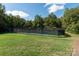 A fenced tennis court nestled in a verdant setting provides recreational opportunity at 1873 Farrow Dr, Rock Hill, SC 29732