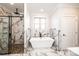 Luxurious bathroom featuring a soaking tub, a walk-in shower, and marble accents at 3778 Rock Bridge Ne Dr, Conover, NC 28613
