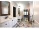 Hallway bathroom with double sinks and marble floors at 3778 Rock Bridge Ne Dr, Conover, NC 28613