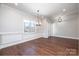 Open dining area with hardwood floors, modern light fixture, and wainscoting at 3778 Rock Bridge Ne Dr, Conover, NC 28613