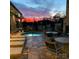 Evening view of hot tub with fireplace and seating area at 3778 Rock Bridge Ne Dr, Conover, NC 28613