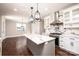Bright kitchen with white cabinets, an island, marble countertops, and modern stainless steel appliances at 3778 Rock Bridge Ne Dr, Conover, NC 28613