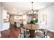 Bright kitchen featuring white cabinets, an island, marble countertops, and a modern dining area at 3778 Rock Bridge Ne Dr, Conover, NC 28613