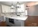 Bright kitchen with an island, white cabinets, stainless steel appliances, and marble countertops at 3778 Rock Bridge Ne Dr, Conover, NC 28613