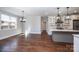 Kitchen area featuring dark hardwood floors, modern lighting, a marble countertop island, and white cabinets at 3778 Rock Bridge Ne Dr, Conover, NC 28613
