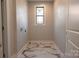 Functional laundry room with marble tile and window at 3778 Rock Bridge Ne Dr, Conover, NC 28613