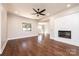 Beautiful living room with hardwood flooring, ceiling fan, and a modern fireplace feature wall at 3778 Rock Bridge Ne Dr, Conover, NC 28613