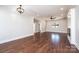 A spacious living room with hardwood floors, a ceiling fan, and neutral wall paint throughout at 3778 Rock Bridge Ne Dr, Conover, NC 28613