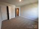 Neutral bedroom with carpet, walk-in closet, and doorway to another room at 4073 Port Richmond Ave # 17, Gastonia, NC 28056