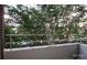 Outdoor balcony with concrete flooring, stainless steel railing, and lush foliage views at 1300 Reece Rd # 302, Charlotte, NC 28209