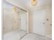 Bright bedroom featuring closet with mirrored sliding doors and neutral carpeting at 1300 Reece Rd # 302, Charlotte, NC 28209