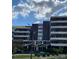 Exterior shot of the building's facade with white lettering and a well-manicured front yard at 1300 Reece Rd # 302, Charlotte, NC 28209