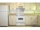This kitchen features a white refrigerator, stove, and light colored countertops at 1300 Reece Rd # 302, Charlotte, NC 28209