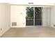 Bright Living Room featuring neutral carpeting and sliding door to balcony at 1300 Reece Rd # 302, Charlotte, NC 28209
