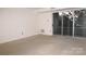 Bright Living Room featuring neutral carpeting and sliding door to balcony at 1300 Reece Rd # 302, Charlotte, NC 28209