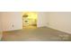 Bright Living Room featuring neutral carpeting with partial view of kitchen appliances at 1300 Reece Rd # 302, Charlotte, NC 28209