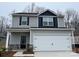 Two-story house with gray siding, white garage door, and stone accents at 3532 Clover Valley Dr, Gastonia, NC 28052