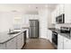 Modern kitchen with white cabinets, granite countertops, and stainless steel appliances at 3532 Clover Valley Dr, Gastonia, NC 28052