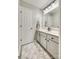 Bright bathroom featuring a white vanity, framed mirror, and decorative rug at 6421 Chadwell Ct # 61, Fort Mill, SC 29707