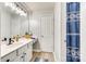 Bathroom with white vanity, bright mirror and blue-patterned shower curtain at 6421 Chadwell Ct # 61, Fort Mill, SC 29707