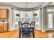 Bright dining room with bay windows, wooden table, hardwood floors, and hanging plants at 6421 Chadwell Ct # 61, Fort Mill, SC 29707