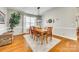 Cozy dining room featuring a wooden table, hardwood floors, window, and wreath at 6421 Chadwell Ct # 61, Fort Mill, SC 29707