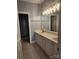 Modern bathroom with double vanity, stylish lighting, and tiled floors at 11311 Olde Turnbury Ct, Charlotte, NC 28277