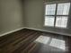 Bright bedroom featuring wood floors and a large window at 11311 Olde Turnbury Ct, Charlotte, NC 28277