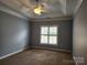 Spacious bedroom with neutral walls, carpet floors, and a ceiling fan at 11311 Olde Turnbury Ct, Charlotte, NC 28277