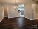 Open dining room with hardwood floors, chandelier, and access to the kitchen at 11311 Olde Turnbury Ct, Charlotte, NC 28277