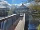 Picturesque gazebo on a pond, accessible by a wooden walkway, creating a tranquil outdoor space at 11311 Olde Turnbury Ct, Charlotte, NC 28277