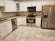 Bright kitchen featuring stainless steel appliances and white cabinetry at 11311 Olde Turnbury Ct, Charlotte, NC 28277