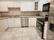 Bright kitchen featuring stainless steel appliances and white cabinetry at 11311 Olde Turnbury Ct, Charlotte, NC 28277