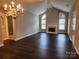 Elegant living room featuring a fireplace, hardwood floors, and ample natural light at 11311 Olde Turnbury Ct, Charlotte, NC 28277