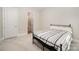 Bedroom with black metal bed frame, patterned bedding, and ensuite bathroom at 1390 Cedardale Ln, Denver, NC 28037