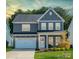 Two-story house with gray siding, white trim, and a two-car garage at 1390 Cedardale Ln, Denver, NC 28037