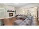 Open living room showcasing a cozy fireplace and sectional sofa at 1390 Cedardale Ln, Denver, NC 28037