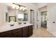 Bright bathroom featuring double sinks, a shower, and tile flooring at 4741 Nijinsky Ct, Charlotte, NC 28216