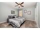 Comfortable bedroom features a ceiling fan and stylish bedding, creating a serene, restful ambiance at 4741 Nijinsky Ct, Charlotte, NC 28216