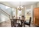 Elegant dining area featuring stylish furnishings, a modern chandelier, and ample natural light at 4741 Nijinsky Ct, Charlotte, NC 28216