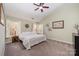 Bright main bedroom featuring vaulted ceiling, ceiling fan, and multiple windows at 4741 Nijinsky Ct, Charlotte, NC 28216