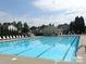 Community pool with lane dividers, lounge chairs, a lifeguard station, and surrounding neighborhood homes at 4741 Nijinsky Ct, Charlotte, NC 28216