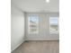 Bedroom with neutral carpet and two bright windows at 939 Cobbled Way, Fort Mill, SC 29715