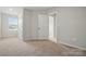 Carpeted bedroom with white trim, a window, and closet at 939 Cobbled Way, Fort Mill, SC 29715